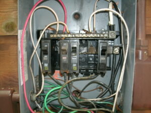 Picture of an old damaged electrical panel. Needs to be upgraded.