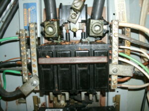 Picture of the main electrical breaker inside a failing electrical panel